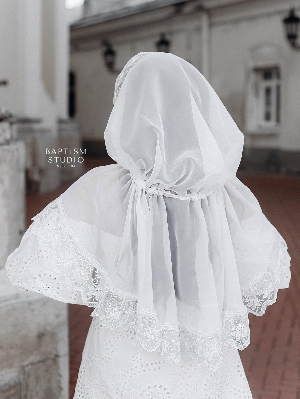 Christian woman wearing elegant white lace prayer veil outdoors, modest church head covering