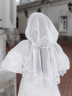 Christian woman wearing elegant white lace prayer veil outdoors, modest church head covering