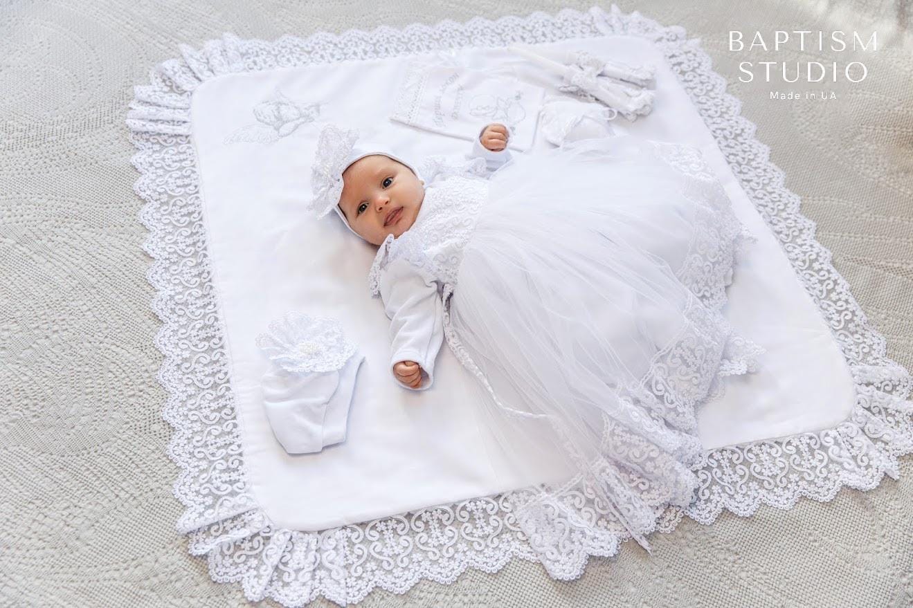 White baptism outfit with dress, pants, headband, booties, and hat
