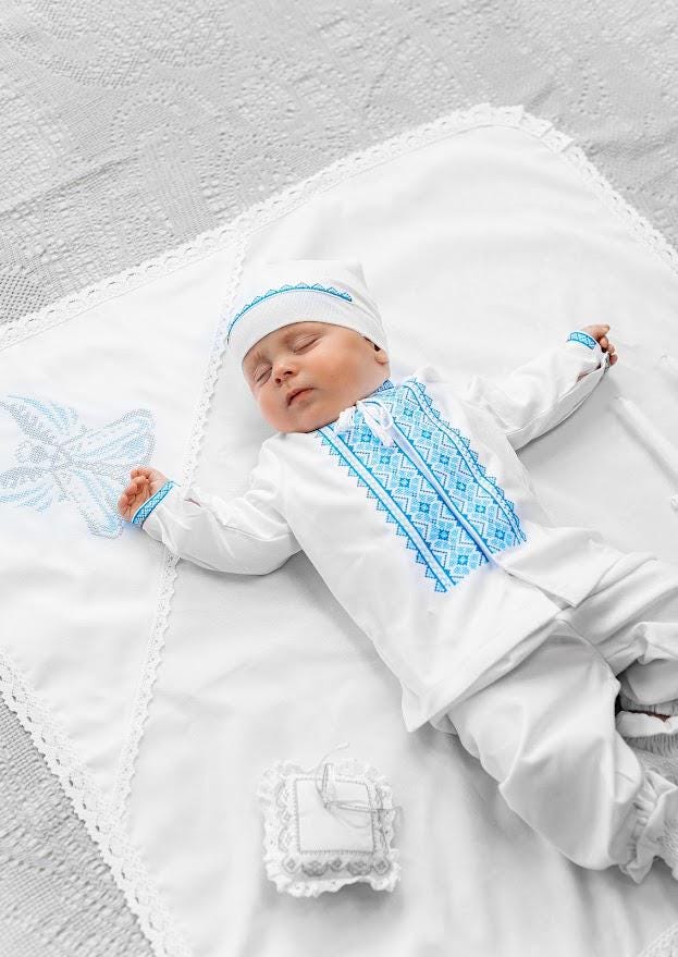 Linen christening blanket with lace and embroidered cross