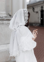 Woman wearing a white lace chapel veil, lightweight tulle church head covering with floral lace edging