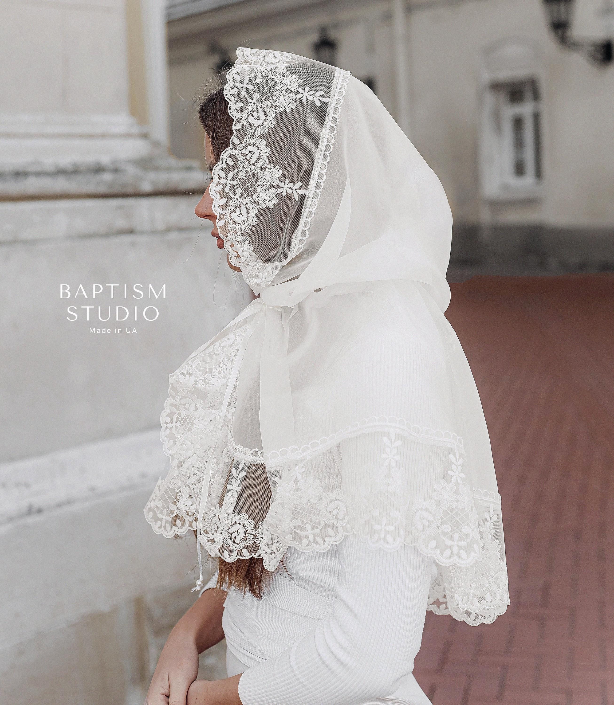 Woman wearing white lace church palantine, lightweight tulle prayer shawl covering head and shoulders
