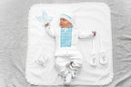 Baby boy in linen christening outfit with embroidered shirt, hat and booties