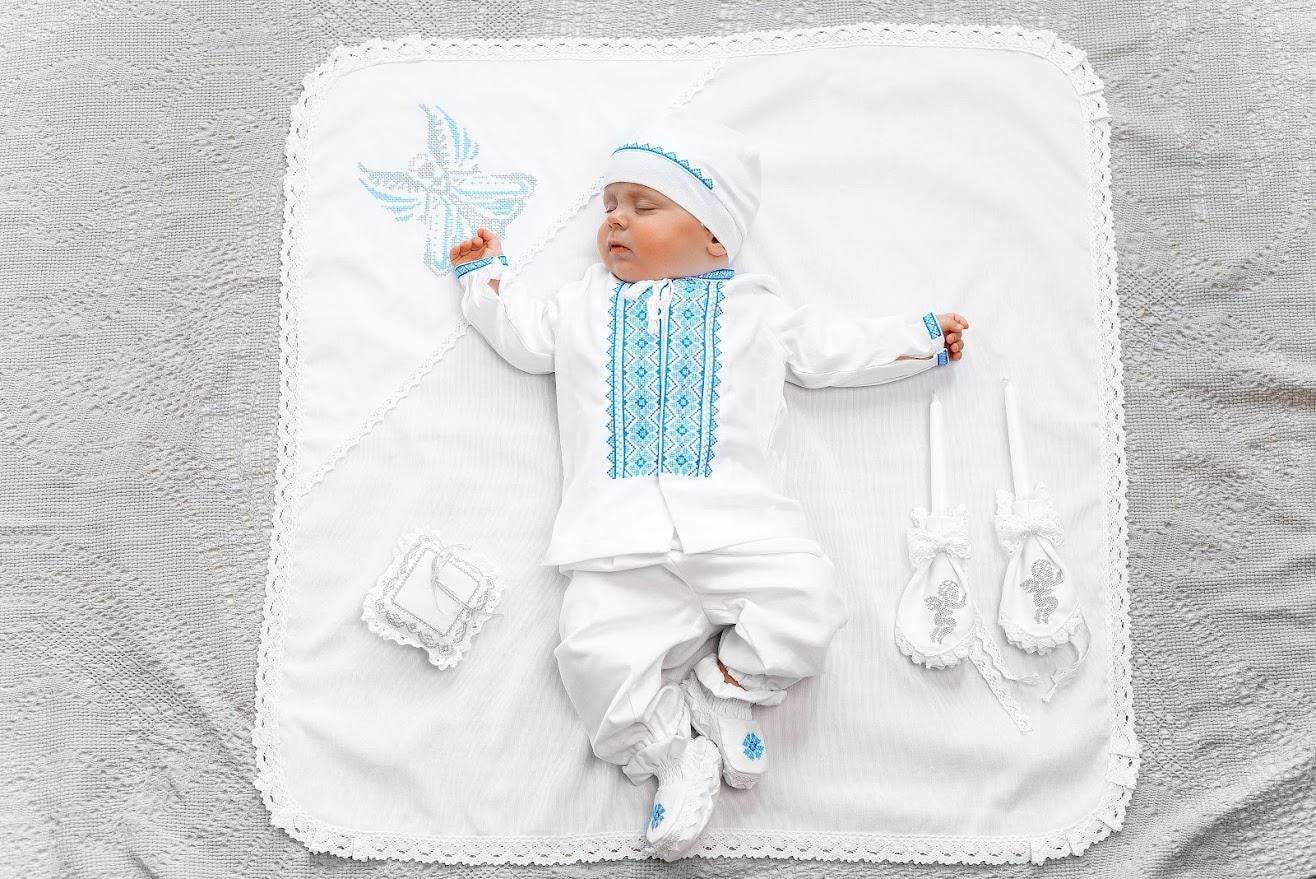 Baby boy in linen christening outfit with embroidered shirt, hat and booties