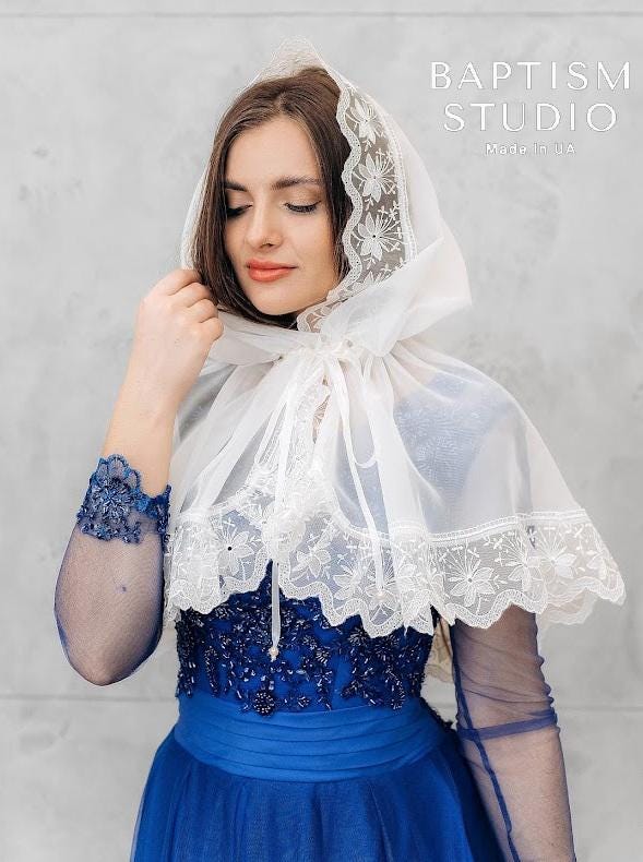 Woman wearing white lace Orthodox baptism veil